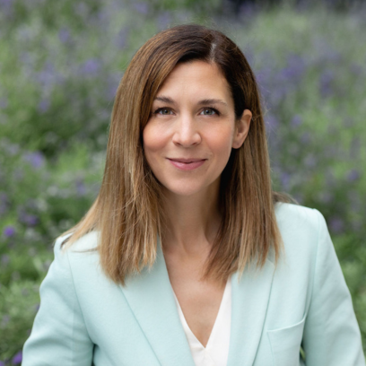 Headshot of Kate Hammer with a slight smile on her face. She has light brown hair and green eyes.